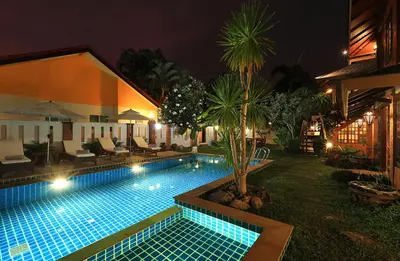 a swimming pool in the yard of a house at night at WoLin Lemon Resort in Ban Saiyuan (1)