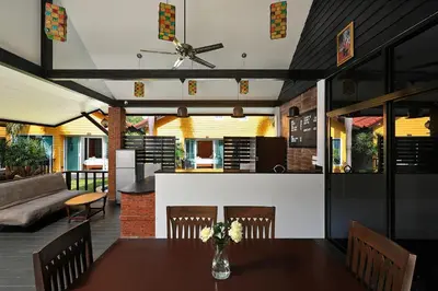 a dining room and living room with a table and chairs at WoLin Lemon Resort in Ban Saiyuan (1)