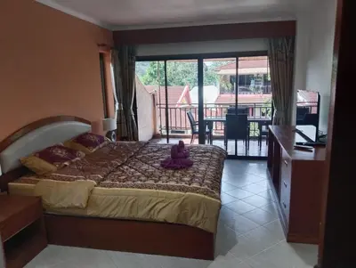 a bedroom with a bed with a teddy bear sitting on it at Appartamento Patong Beach, all'interno del Sai Rougn residence in Patong Beach