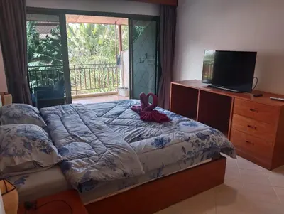 a bedroom with a bed with a bow on it at Appartamento Patong Beach, all'interno del Sai Rougn residence in Patong Beach