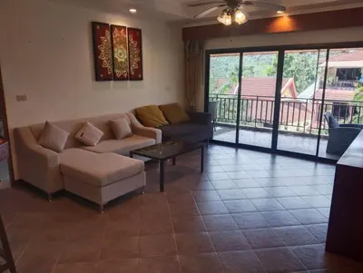 a living room with a couch and a coffee table at Appartamento Patong Beach, all'interno del Sai Rougn residence in Patong Beach
