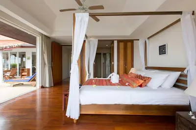 a bedroom with a large bed with a ceiling fan at Katamanda villa Moon 3 Bed seaview near Kata Beach in Kata Beach