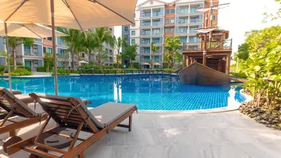 a swimming pool with two chairs and an umbrella at С8 С9 ВАТСАП669З582I976 принимаем РУБЛИ in Nai Yang Beach