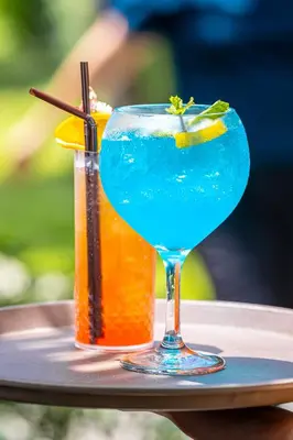 a blue margarita and a drink on a tray at Malabar Pool Villa Phuket in Phuket Town
