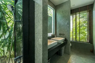 a bathroom with a sink and a mirror at Baan Bua BT17 by Villacarte in Nai Harn Beach