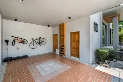 a house with two bikes hanging on the wall at Baan Bua BT17 by Villacarte in Nai Harn Beach