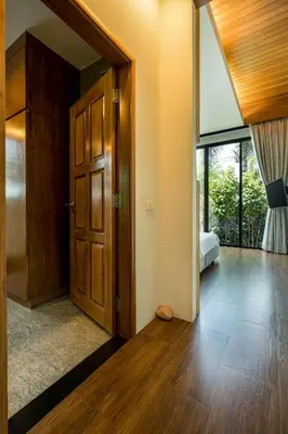 an open door in a room with a bedroom at Baan Bua BT17 by Villacarte in Nai Harn Beach