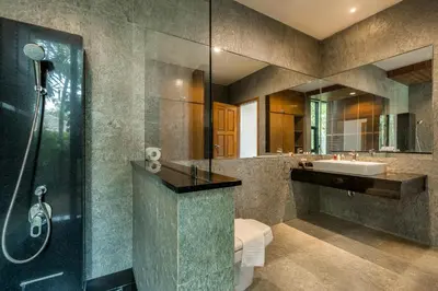 a bathroom with a shower and a toilet and a sink at Baan Bua BT17 by Villacarte in Nai Harn Beach