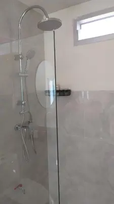 a shower with a glass door in a bathroom at RadHut in Chalong