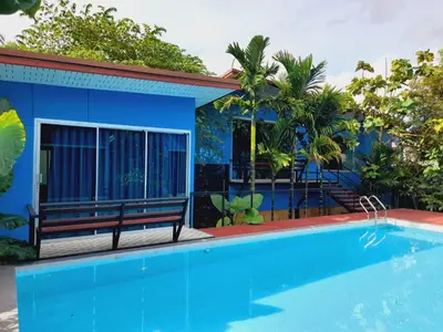 a blue house with a blue swimming pool at RadHut in Chalong