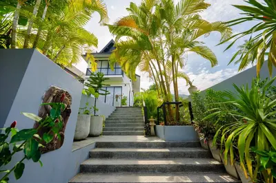 a stairway leading up to a house with palm trees at Yao Bada Badoo Boutique Resort in Ko Yao Yai