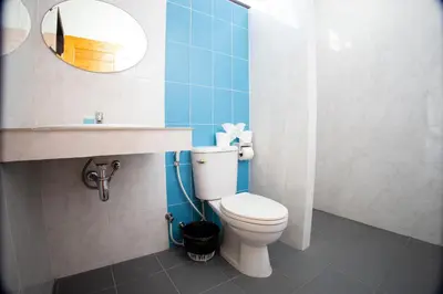a bathroom with a toilet and a sink and a mirror at Grand View Premium in Patong Beach