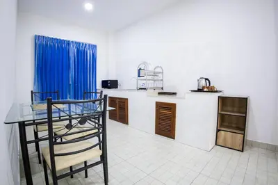 a kitchen with a counter and a table in it at Grand View Premium in Patong Beach