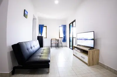a living room with a couch and a flat screen tv at Grand View Premium in Patong Beach