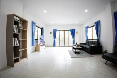 a living room with blue curtains and a couch at Grand View Premium in Patong Beach