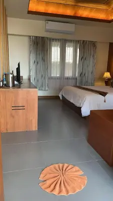 a bedroom with a bed and a desk with a television at Better View Koh Yao Yai in Ko Yao Yai