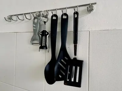 a group of kitchen utensils hanging on a wall at 103/24 Kathu Waterfall in Phuket Town