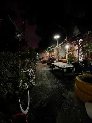 a backyard at night with a ping pong table at PhuketAirportCamping in Mai Khao Beach