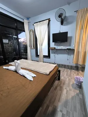 a bedroom with a bed with white towels on it at PhuketAirportCamping in Mai Khao Beach