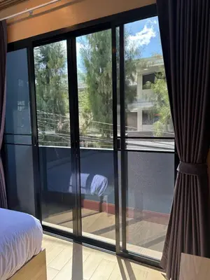a bedroom with sliding glass doors with a view at Kata Noi Place in Kata Beach