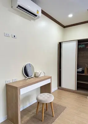 a room with a table and a stool and a fan at Kata Noi Place in Kata Beach