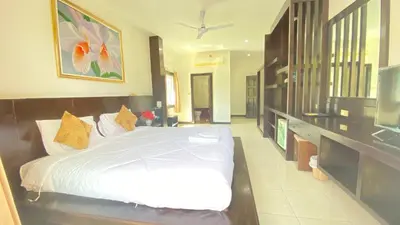 a bedroom with a white bed in a room at SM Patong Resort in Patong Beach