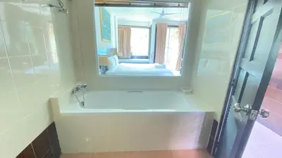 a bathroom with a sink and a mirror at SM Patong Resort in Patong Beach