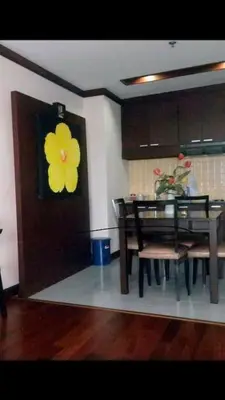 a dining room with a yellow flower on the door at Patong Tower Ocean View Apartment in Patong Beach