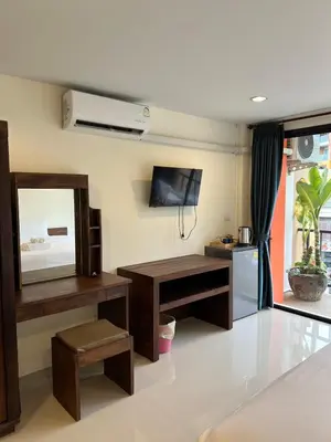 a living room with a table and a mirror at Rawai Sea Beach in Phuket Town
