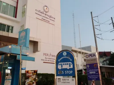 a bus stop sign in front of a building at STPhostel in Patong Beach