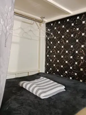 a bedroom with a bed with a towel on it at STPhostel in Patong Beach