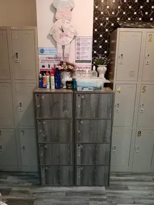 a row of lockers in a locker room with a clock at STPhostel in Patong Beach
