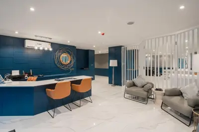 a kitchen with blue walls and chairs and a counter at Kamala Beach P79 Exclusive Junior Suite in Kamala Beach