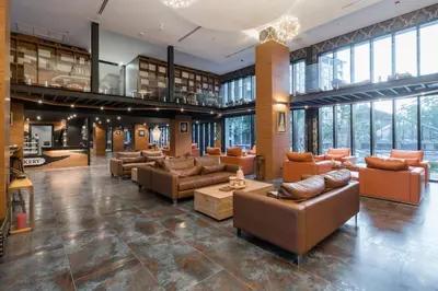 a large room with couches and tables in a building at Kamala Beach P79 Exclusive Junior Suite in Kamala Beach