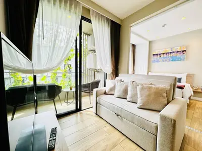 a living room with a couch and a piano at Daimond Exclusive Junior Suite Bangtau Beach in Bang Tao Beach