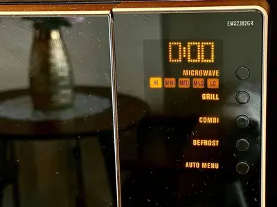 a close up of a digital clock with a vase at Daimond Exclusive Junior Suite Bangtau Beach in Bang Tao Beach
