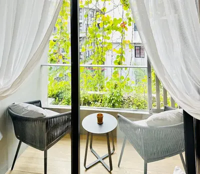 a room with two chairs and a table and a window at Daimond Exclusive Junior Suite Bangtau Beach in Bang Tao Beach