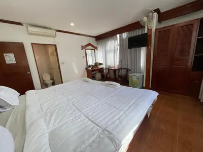 a bedroom with a large white bed in a room at Centre Point Patong in Patong Beach