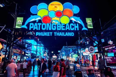 a crowd of people walking down a busy city street at Centre Point Patong in Patong Beach