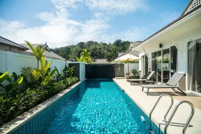 a swimming pool in the backyard of a house at Deluxe pool villa at Kamala Garden View in Kamala Beach