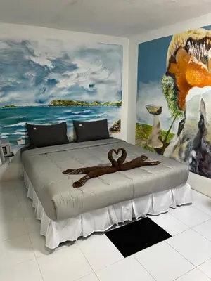 a bedroom with a large bed with a monkey on it at Reggaeinn in Phi Phi Don