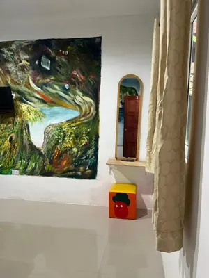a room with two paintings on the wall at Reggaeinn in Phi Phi Don