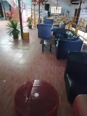 a living room with blue couches and a table at Reggaeinn in Phi Phi Don