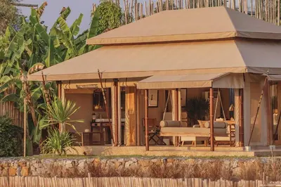 a house with a large umbrella in front of it at Aladdin Luxury Camp Phuket in Phuket Town