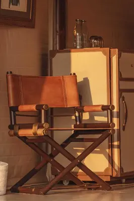 a wooden chair sitting in front of a refrigerator at Aladdin Luxury Camp Phuket in Phuket Town