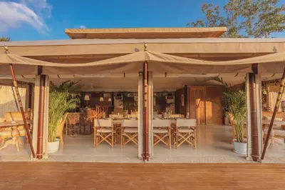 a pavilion with a table and chairs under it at Aladdin Luxury Camp Phuket in Phuket Town