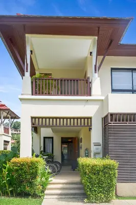 a house with a balcony on top of it at Laguna Luxury 2-Bed Pool Villa - Near Layan Beach in Layan Beach