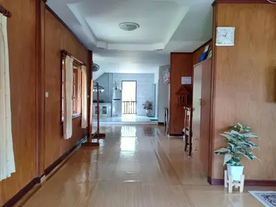 a hallway with wood paneling and a hallway with a plant at Bang Yan Rimlay in Ko Yao Noi