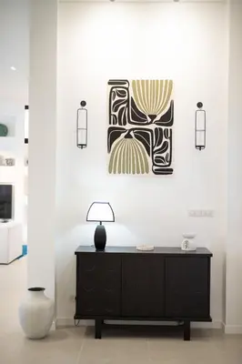 a black dresser in a white room with a painting at Nai Harn Beach 4 bedroom Pool Villa, Rawai, Phuket in Phuket Town