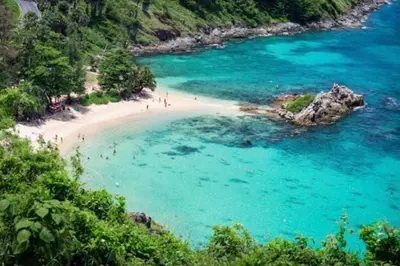 a beach with a group of people in the water at Nai Harn Beach 4 bedroom Pool Villa, Rawai, Phuket in Phuket Town